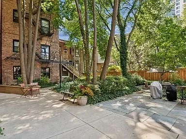 a backyard of a house with lots of green space and fountain