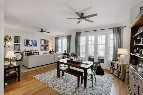 a living room with furniture a rug and a window
