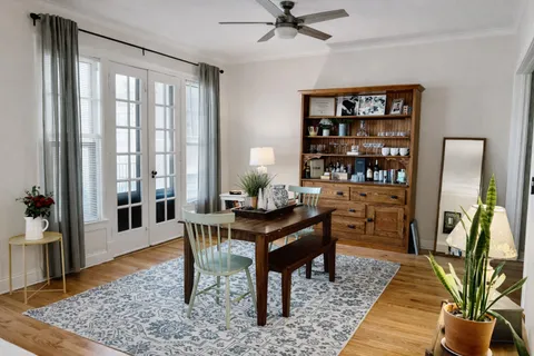 a view of a workspace with furniture and wooden floor