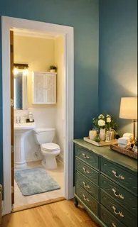 a bathroom with a granite countertop toilet a sink and a large mirror