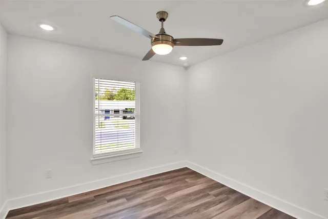 wooden floor in an empty room with a window