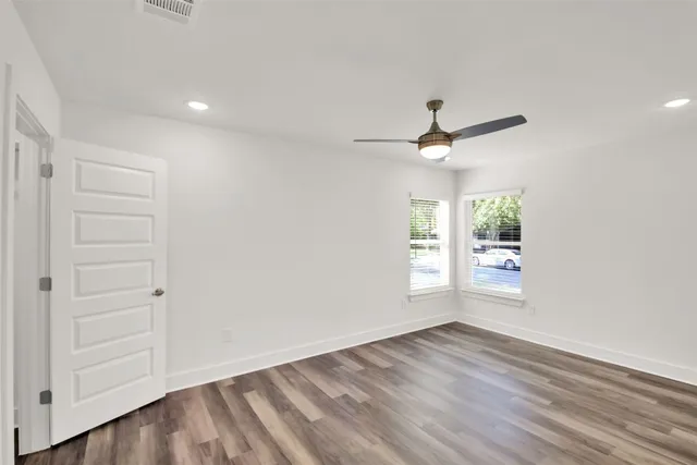 wooden floor in an empty room with a window