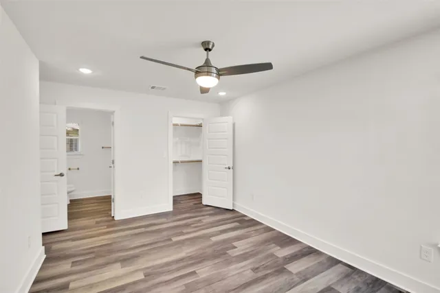 a view of an empty room and wooden floor