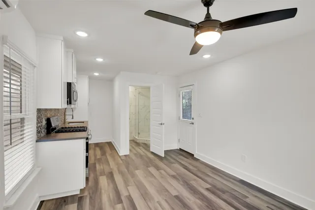 a view of a kitchen with a sink and dishwasher wooden floor