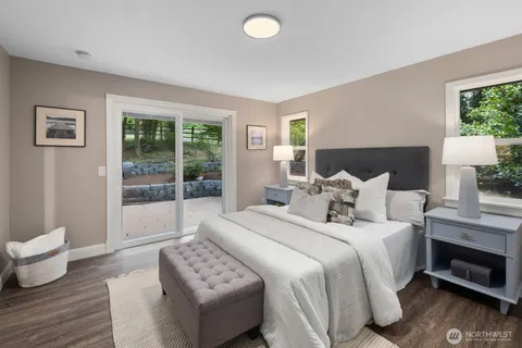 a bedroom with bed and wooden floor