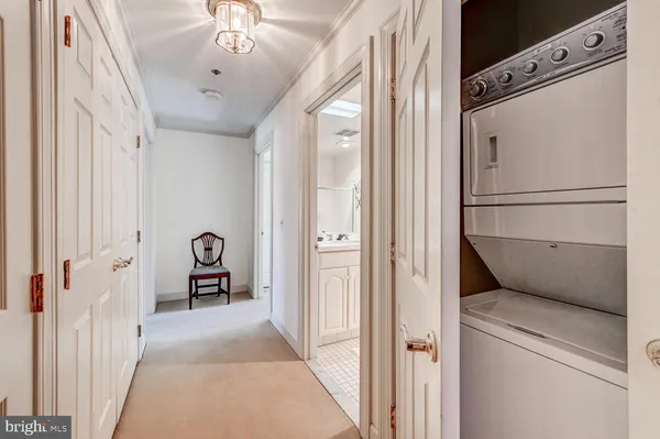 a view of a hallway with a refrigerator and a stove top oven