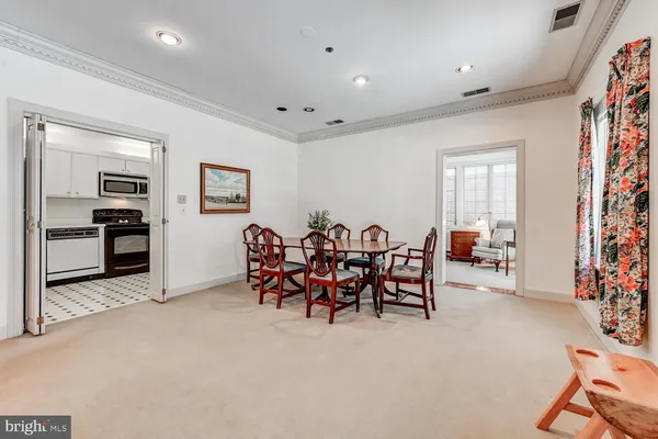 a view of a dining room with furniture and a chandelier