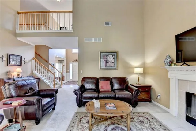a kitchen with granite countertop a sink a counter top space cabinets stainless steel appliances and a window