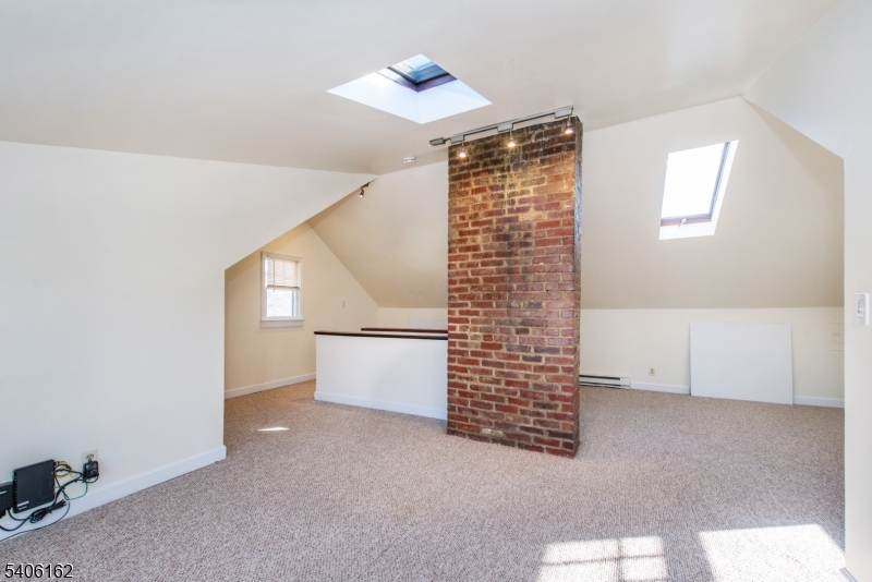 39 Baldwin Place, Unit 2 Bloomfield, NJ 07003 - Photo 15 of 17 a view of an empty room with windows