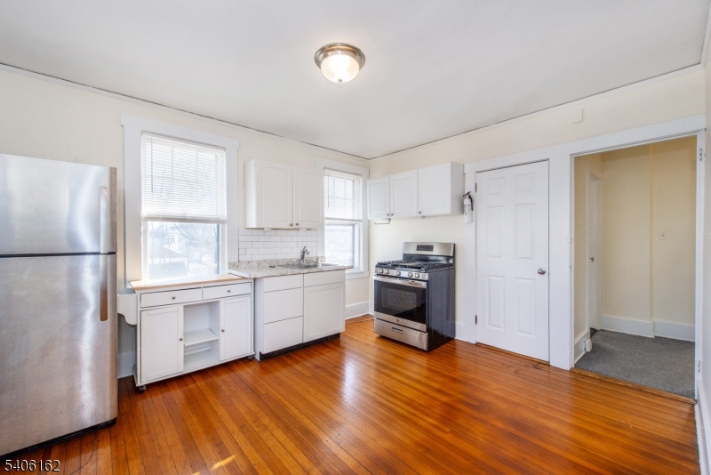 39 Baldwin Place, Unit 2 Bloomfield, NJ 07003 - Photo 3 of 17 a kitchen with granite countertop a refrigerator stove top oven and sink