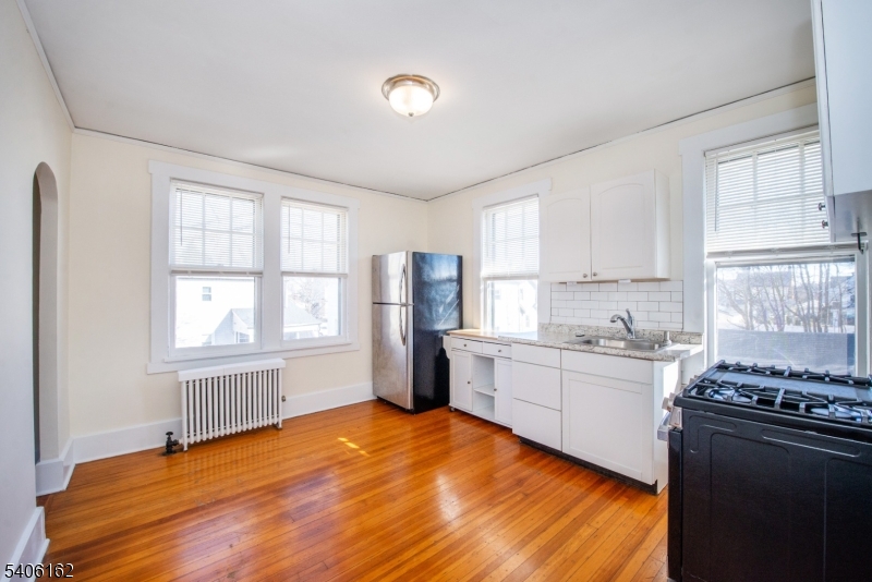 39 Baldwin Place, Unit 2 Bloomfield, NJ 07003 - Photo 4 of 17 a kitchen with a stove a sink dishwasher and a refrigerator