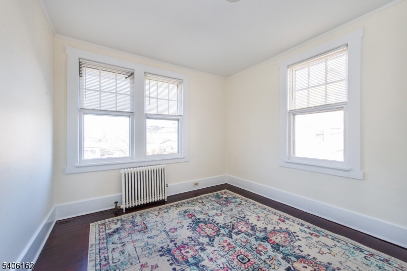39 Baldwin Place, Unit 2 Bloomfield, NJ 07003 - Photo 7 of 17 an empty room with a window