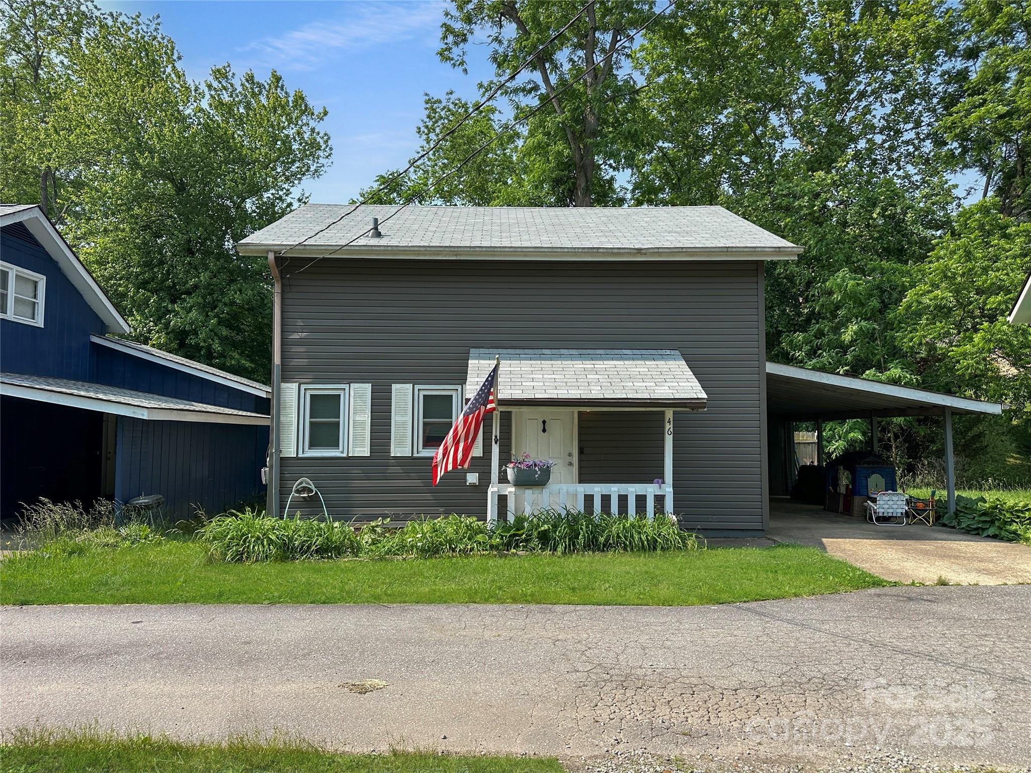 46 Westbrook Circle Clyde, NC 28721 - Photo 2 of 13 a front view of a house with a yard and potted plants