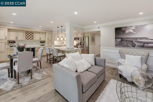 a living room with furniture wooden floor and a large window