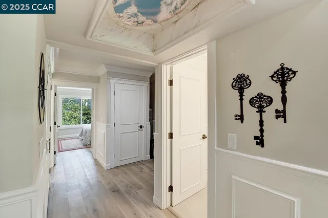 a view of a hallway with wooden floor and front door