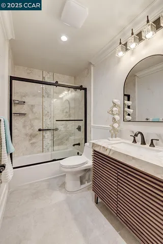 a bathroom with a toilet a sink and a mirror