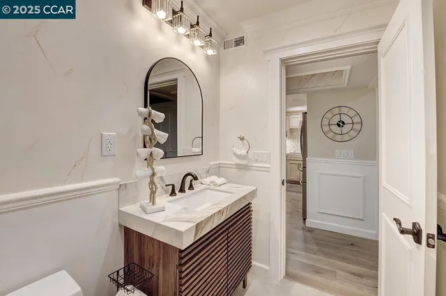 a bathroom with a sink a vanity and a mirror