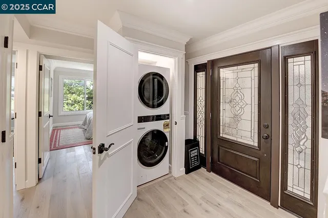 a view of a bedroom with washer and dryer