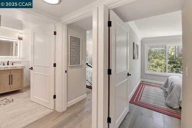 a view of a hallway with closet and wooden floor