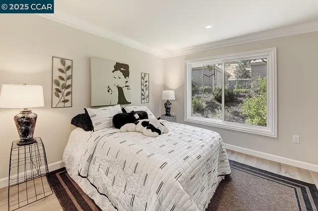 a bed sitting in a bedroom next to a window