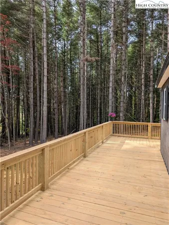a view of a house with a wooden deck
