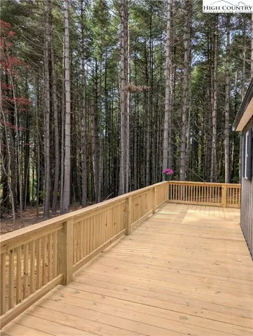 a view of a house with a wooden deck