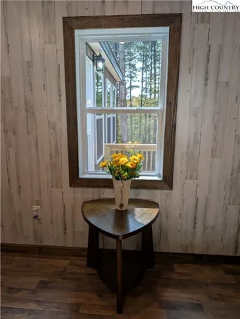 a room with wooden floor and potted plant