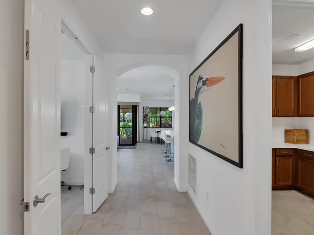 a view of a hallway with wooden shelves