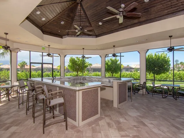 a view of a patio with a table chairs and a backyard