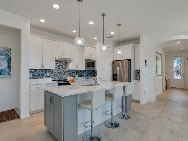 a kitchen with kitchen island appliances and cabinets