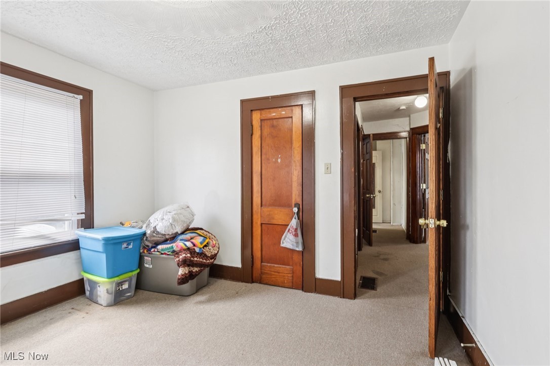 764 Chalker Street Akron, OH 44310 - Photo 23 of 34 Recreation room with carpet flooring and a textured ceiling
