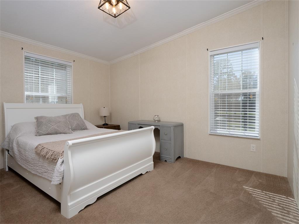 2900 Northwest 68th Avenue Ocala, FL 34482 - Photo 14 of 27 a bed sitting in a bedroom next to a window