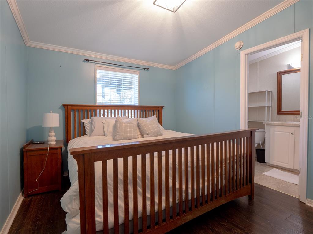 2900 Northwest 68th Avenue Ocala, FL 34482 - Photo 15 of 27 a bedroom with a bed and wooden floor