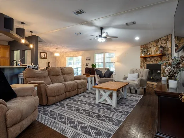 a living room with furniture a chandelier and a rug