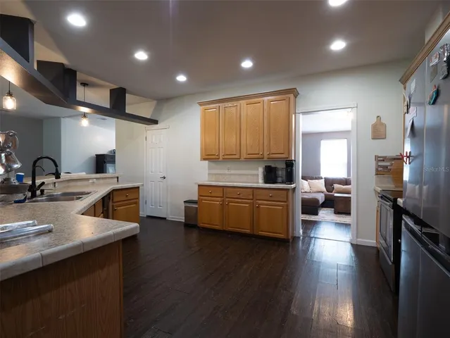 a bathroom with a granite countertop sink a toilet and a mirror