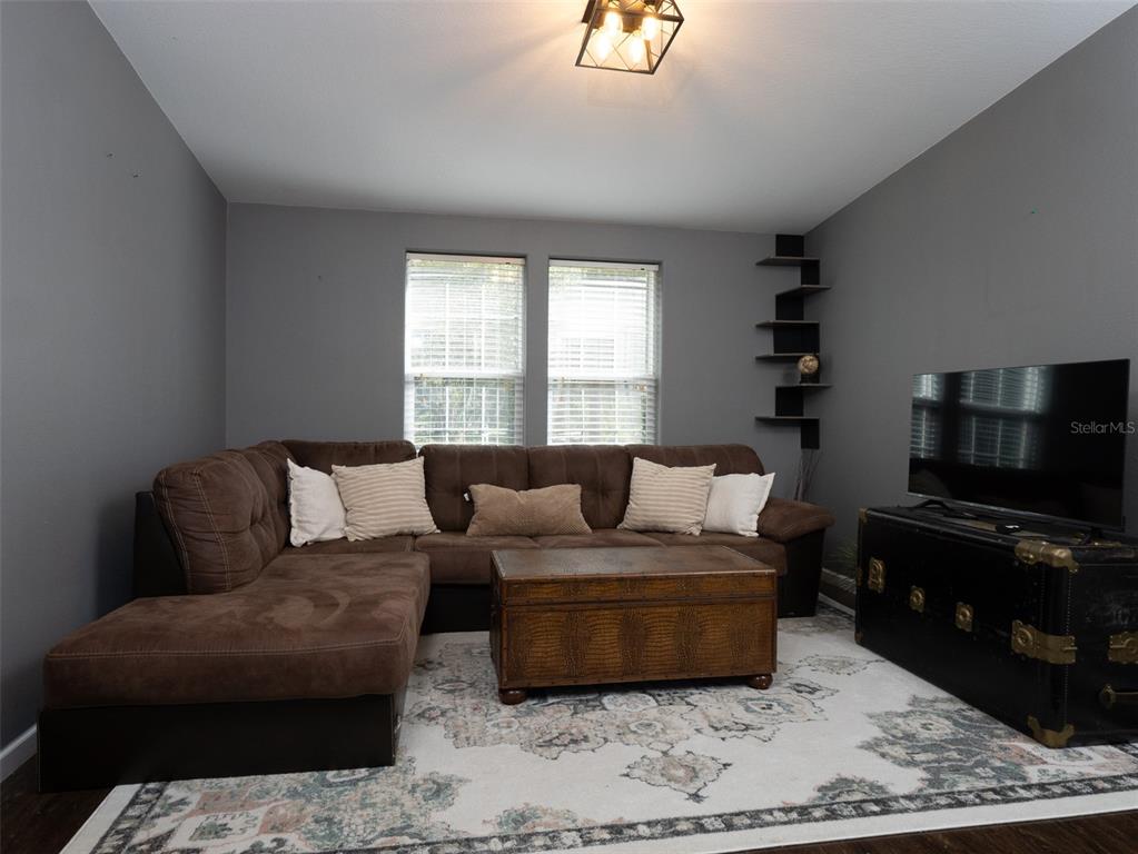 2900 Northwest 68th Avenue Ocala, FL 34482 - Photo 8 of 27 a living room with furniture and a flat screen tv