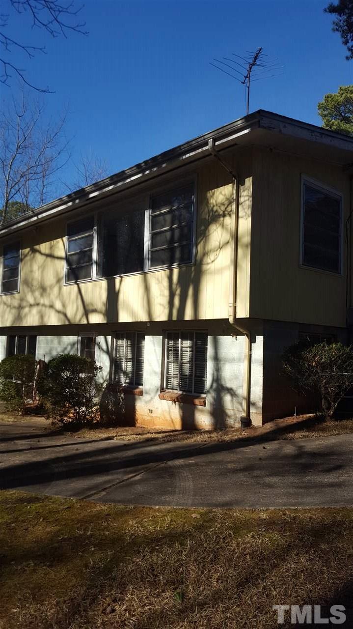 2617 Wells Avenue Raleigh, NC 27608 - Photo 2 of 7 a black and white building with trees in the background