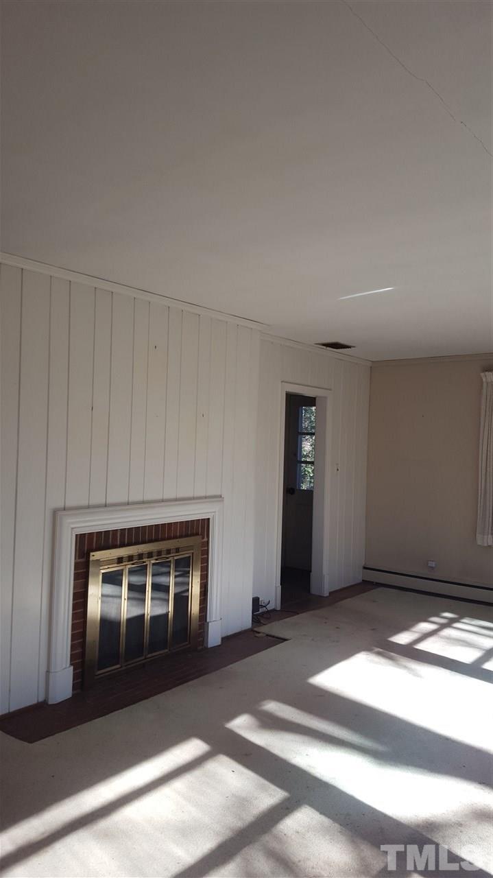 2617 Wells Avenue Raleigh, NC 27608 - Photo 6 of 7 a view of a livingroom with a fireplace