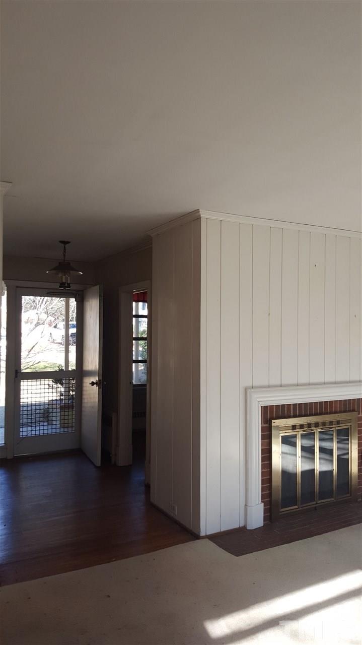 2617 Wells Avenue Raleigh, NC 27608 - Photo 7 of 7 an empty room with wooden floor and windows