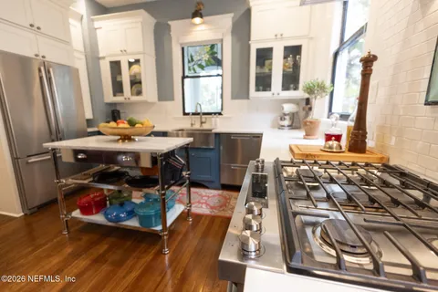 a kitchen with stainless steel appliances granite countertop a stove and a sink