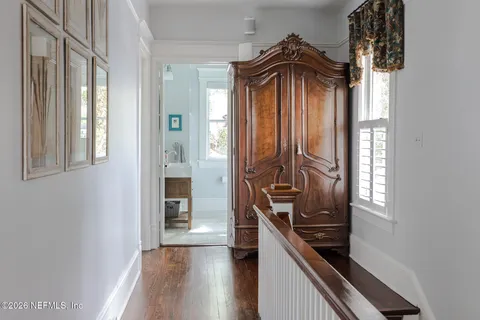 a bathroom with a toilet a sink a mirror and vanity
