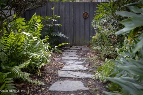a view of a house with potted plants