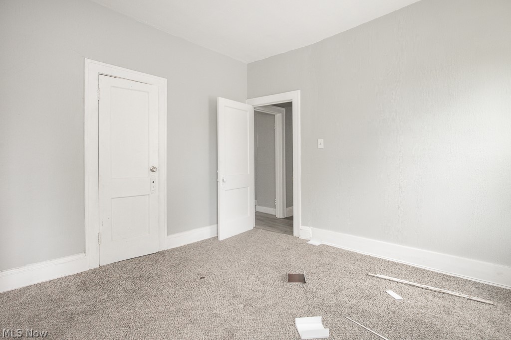 1000 Eddy Road Cleveland, OH 44108 - Photo 35 of 38 Unfurnished bedroom featuring carpet flooring and baseboards