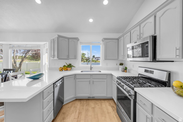 1147 West State Road Lehi, UT 84043 - Photo 9 of 31 Modern kitchen featuring light gray cabinetry, white countertops, and stainless steel appliances