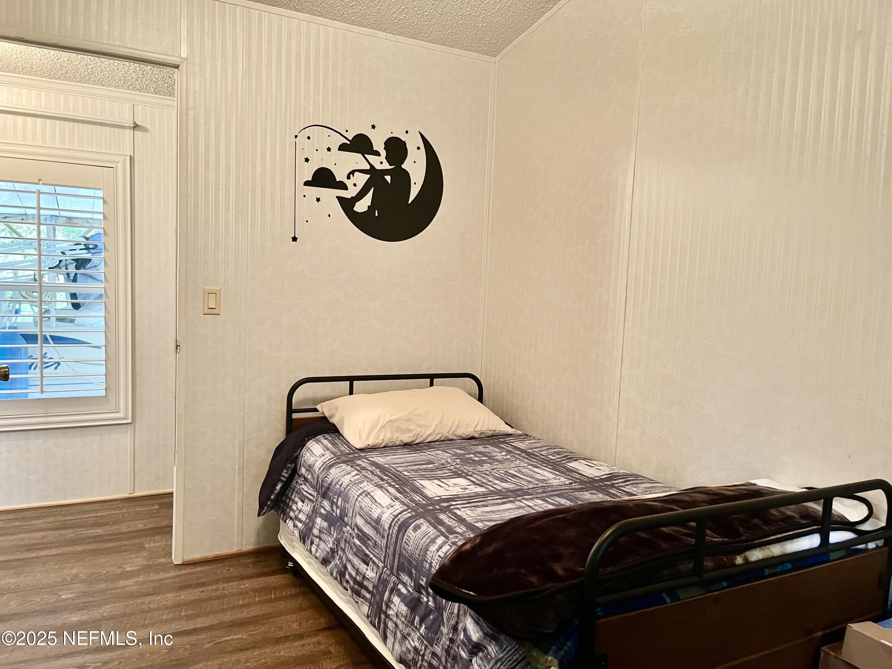 118 July Avenue Georgetown, FL 32139 - Photo 10 of 21 a bedroom with a bed and wooden floor