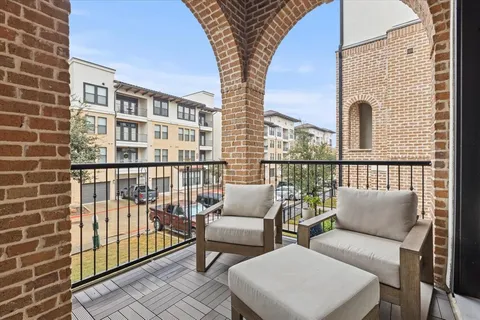 a view of a balcony with furniture