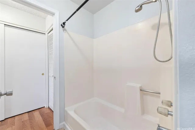a bathroom with a bathtub and a shower