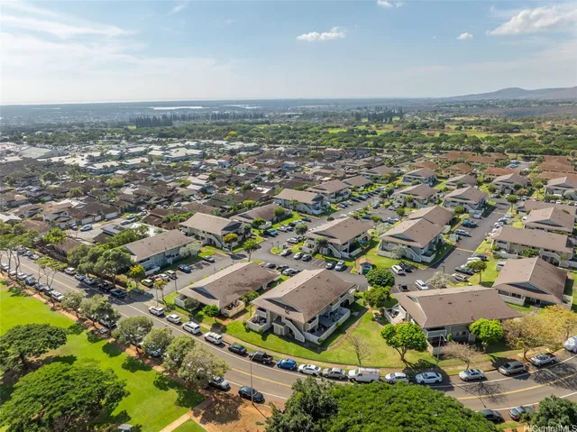an aerial view of residential houses with outdoor space