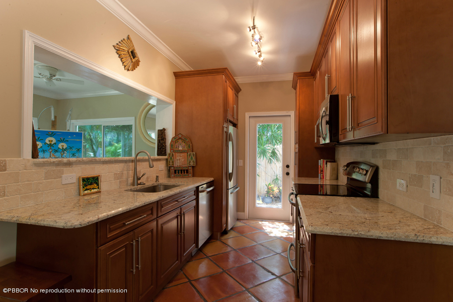 130 Alpine Road West Palm Beach, FL 33405 - Photo 4 of 14 a kitchen with stainless steel appliances granite countertop a sink stove and cabinets