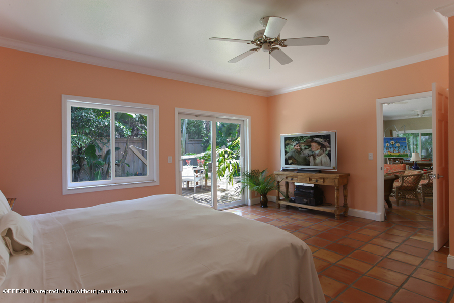130 Alpine Road West Palm Beach, FL 33405 - Photo 6 of 14 a bedroom with a balcony a bed and a chandelier